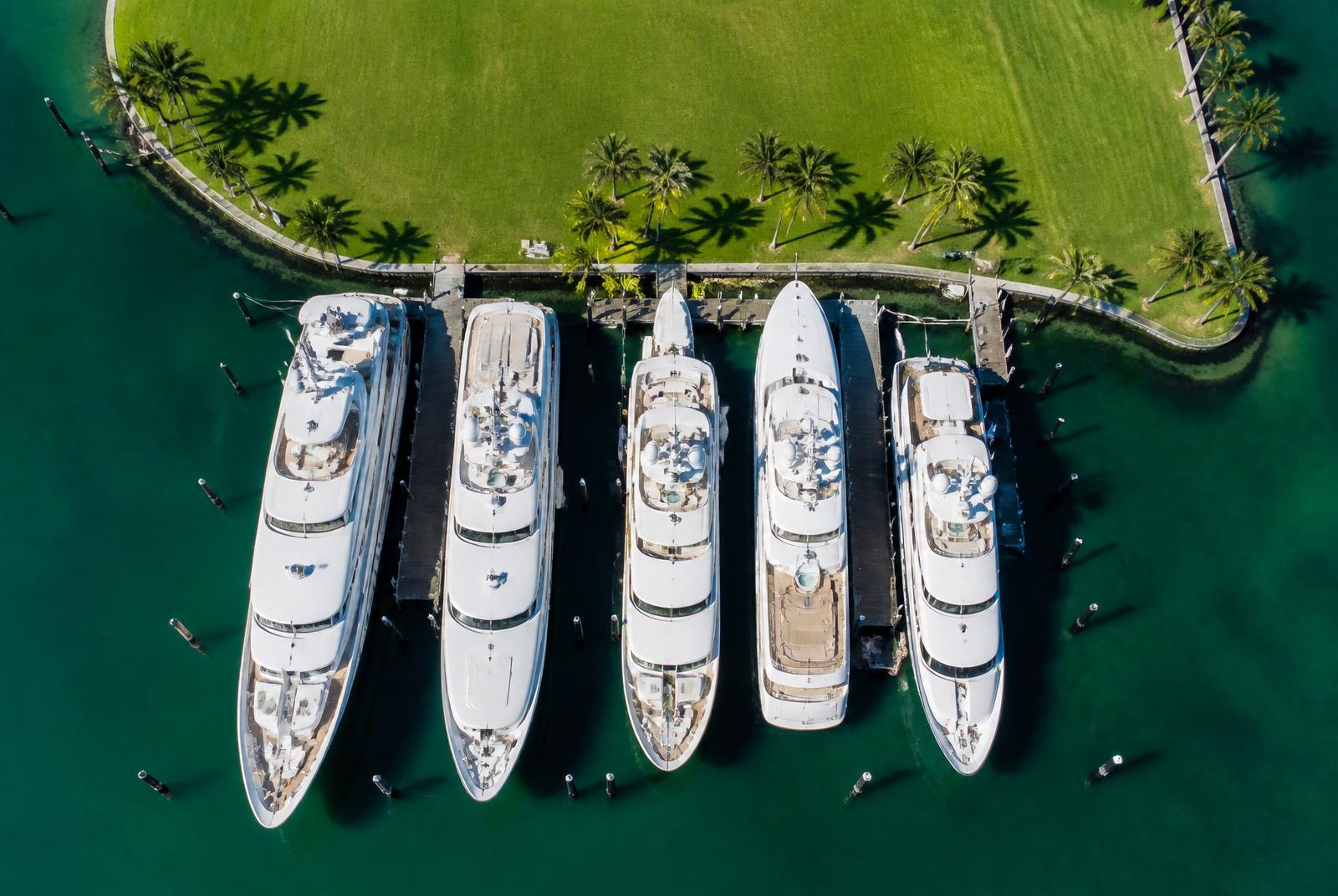 Aerial view of superyachts docked along a South Florida megayacht marina